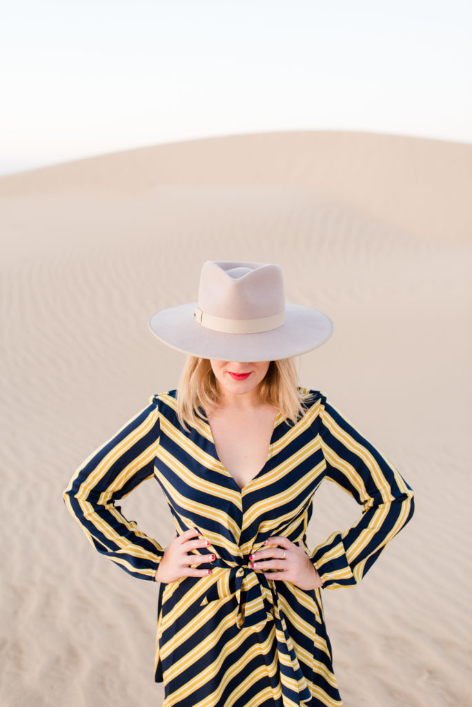 Blonde model at the desert in wide brim hat for brand photos