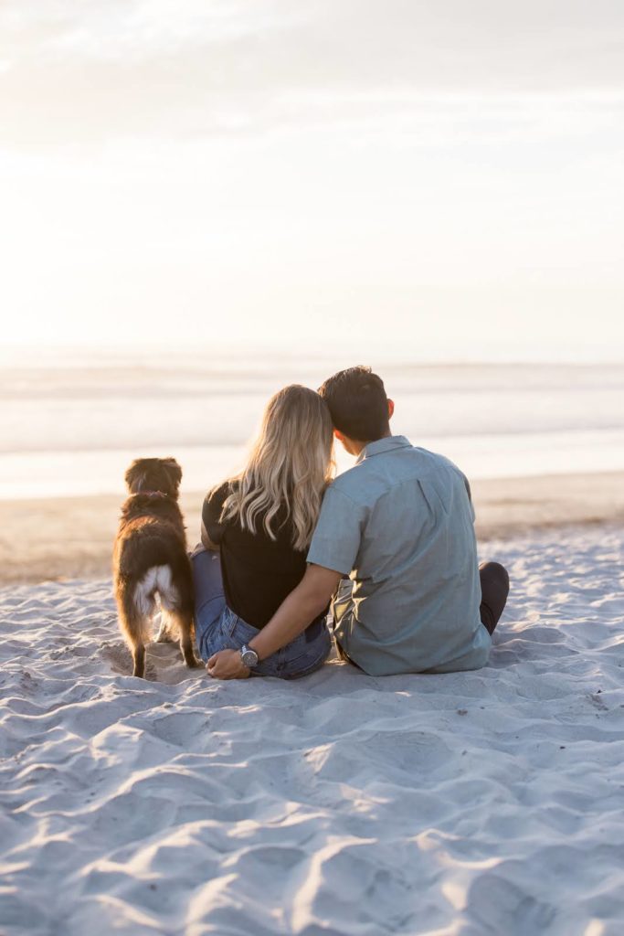 Kellen McAvoy with her dog and hubby looking at the ocean at the San Diego beach.
