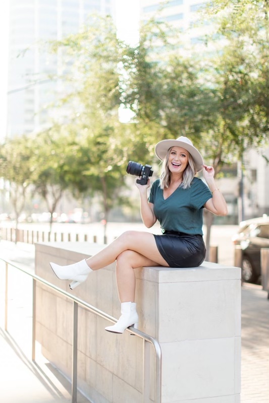 Meg Marie Photo with camera sitting on cement wall