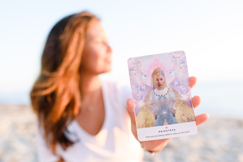 Woman holding up a healing card toward the camera for a close-up. 