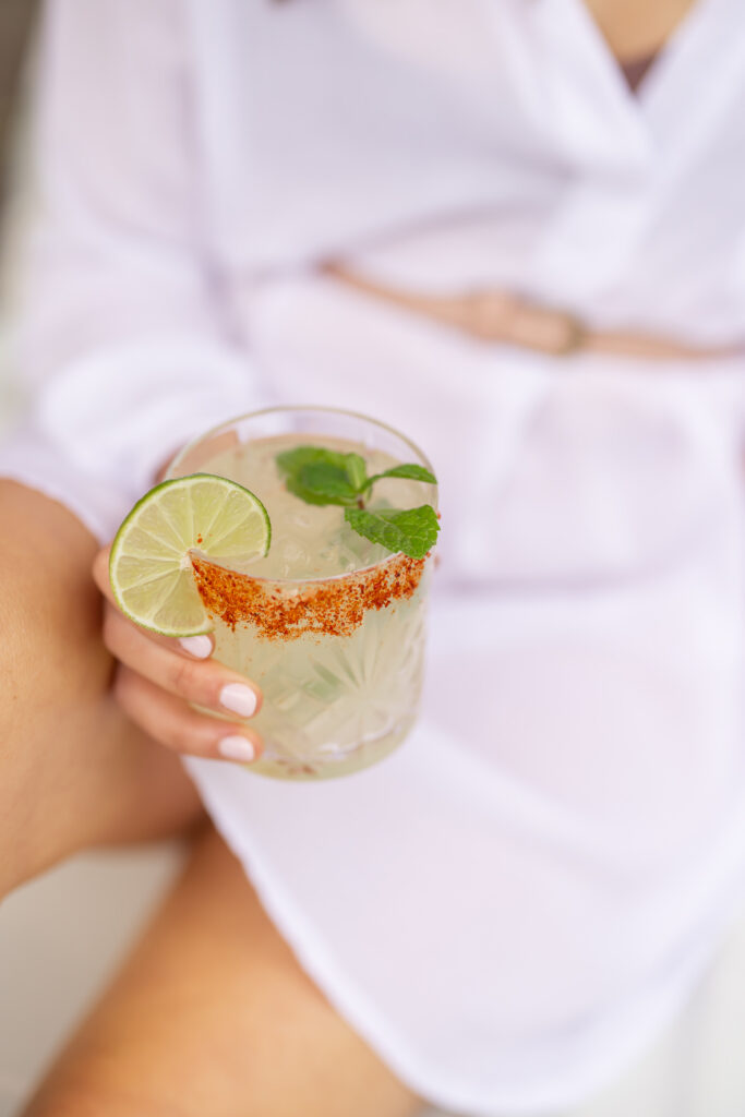 Close-up of a woman’s hands holding an exotic drink. 